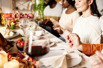 Happy family celebrate Thanksgiving day, sitting at table with roasted turkey and holiday traditional food, dishes.