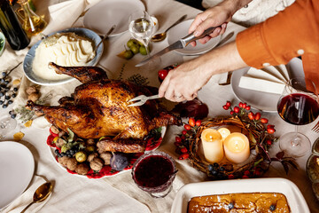 Close-up happy young men and women, married couple celebrate Thanksgiving day. Family dinner with roasted turkey. Top view