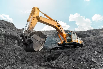 Fotobehang Vrachtwagen Large quarry dump truck. Big yellow mining truck at work site. Loading coal into body truck. Production useful minerals. Mining truck mining machinery to transport coal from open-pit production  © timofeev
