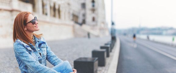 Young redhead hungarian woman relaxing at Parliament building, Budapest, Hungary