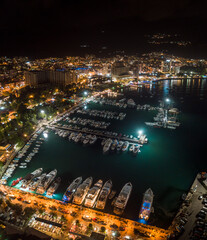 Aerial view of harbor and luxurious yachts in Budva in the night