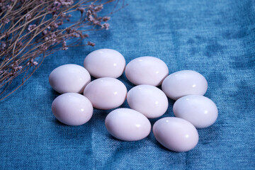 raw white eggs on blue cloth