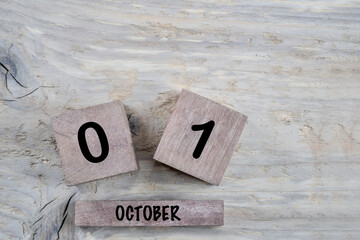 cube calendar for october on wooden background with copy space