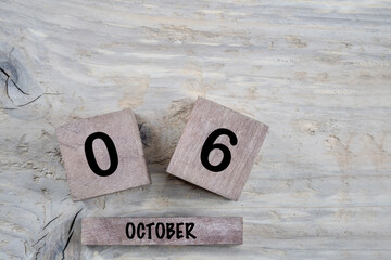 cube calendar for october on wooden background with copy space