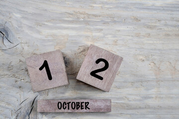 cube calendar for october on wooden background with copy space