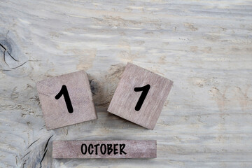 cube calendar for october on wooden background with copy space