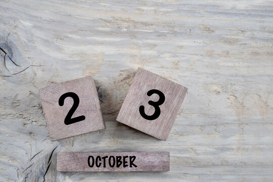 cube calendar for october on wooden background with copy space