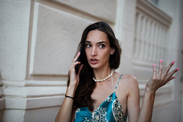 Beautiful young elegance woman using the phone. Beautiful fashion woman talking to the phone.