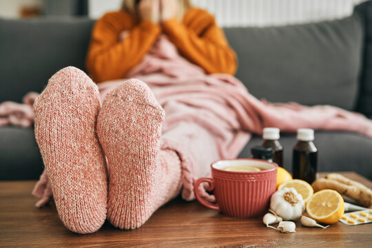 Woman with warm socks having a heavy flu
