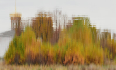 Autumn color is reflected in the still water of the lake