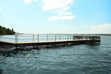 Beautiful river scene with wooden pier on sunny day