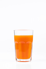 Pumpkin juice in transparent glass isolated on white background. Vegetable vegetarian drink. Healthy food and diet.