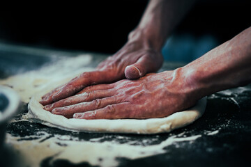 raw dough pastry is being prepared by chef closeup hands man 