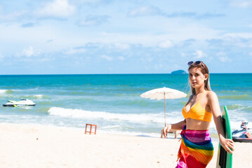 Asian beautiful girl in a sexy bikini standing on the beach in summer.