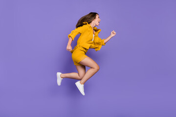 Fototapeta na wymiar Full body profile side photo of cheerful amazed woman jump up hurry cool sale mall isolated on purple color background
