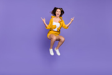 Fototapeta na wymiar Full body photo of crazy brown haired woman jump rock music lover festival isolated on violet color background