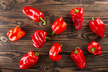 Red paprika peppers on a wooden background. Horizontal orientation, top view.