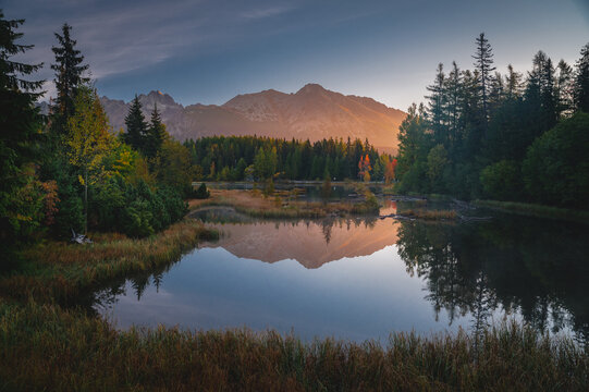 First morning light in mountains. Scenry by lake. Hiking photo. High Tatras, Slovakia