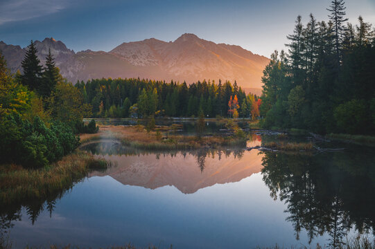 First morning light in mountains. Scenry by lake. Hiking photo. High Tatras, Slovakia