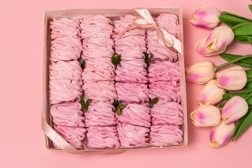 box with marshmallows. pink background. pink marshmallows. flowers for girl
