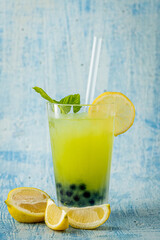 Lemonade with bubble tea on blue stone background