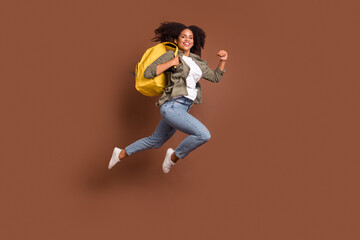 Fototapeta na wymiar Full length profile portrait of carefree energetic person hurry rush fast look camera isolated on brown color background