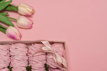 Fotobehang box with marshmallows. pink background. pink marshmallows. flowers for girl © Olleg1