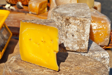 Different types of cheese on the table. Many cheese is sold at an agricultural fair. Natural home product.
