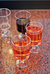 Plastic glasses with wine close up. Different types of wine on a marble table.