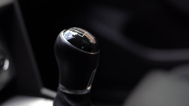 Man driver changing gears with manual transmission gear stick, close up