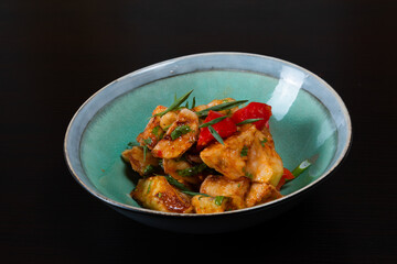 Salad with fried zucchini on a black background