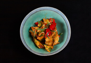 Salad with fried zucchini on a black background