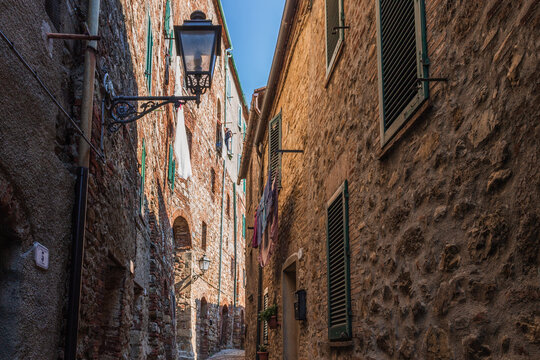 View of narrow street in Chiusdino, Tuscany, Italy. Copy space.
