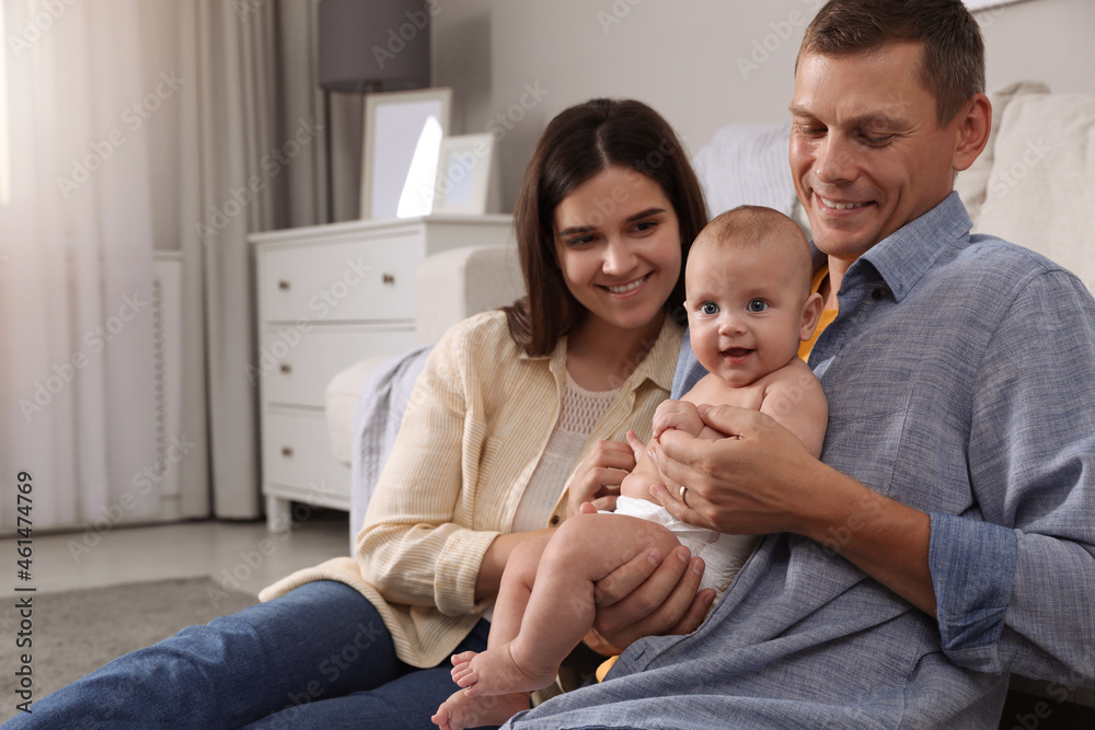 Poster Happy family with their cute baby at home