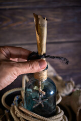 A marine concept with a bottle, starfish, seashells, rope, compass and paper scroll, pirate still life