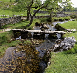 Ancient stone Bridge over small Stream.