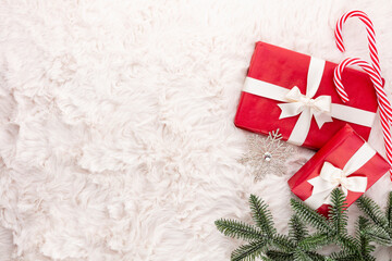 Christmas composition. Gift box, christmas decorations on wool background. Flat lay, top view, copy space.