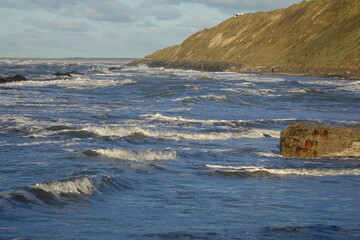 Hiking the coastal path of Lonstrup on a sunny and stormy day, Jammerbugt, Lonstrup, Hjorring, Northern Jutland, Denmark
