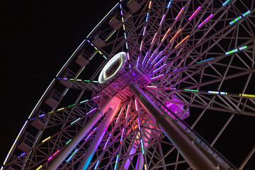 Fototapeta na wymiar illuminated ferris wheel at night