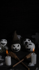 Obraz premium HALLOWEEN, GOLF BALLS DECORATED LIKE PUMPKINS WITH TERRORIFIC FACES WITH CANDLES, FOLIAGE, CROSSES, INSECTS ON RUSTIC WOODEN TABLE AND DARK BACKGROUND WITH SPACE FOR TEXT