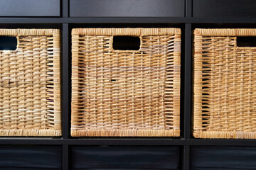 Wicker boxes for things on the shelves. Wardrobe for storage of things. High quality photo