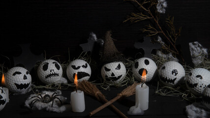 HALLOWEEN, GOLF BALLS DECORATED LIKE PUMPKINS WITH TERRORIFIC FACES WITH CANDLES, FOLIAGE, CROSSES,...