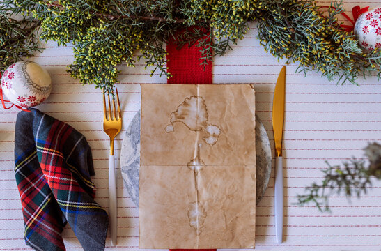 Red holiday place setting with empty menu white tablecloth