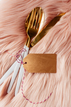 Pink christmas table setting with white and gold cutlery