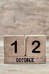 cube calendar for october on wooden background with copy space