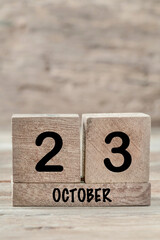 cube calendar for october on wooden background with copy space