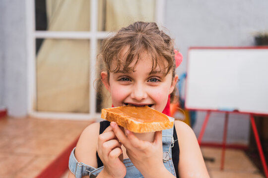 Girl eating bread with jam