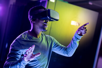 African american male computer technician wearing vr headset and working in server room