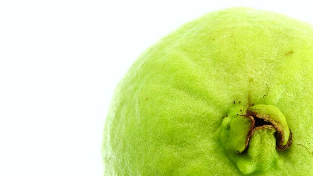 4K macro close up organic sliced red guava rotating plate isolated on white background