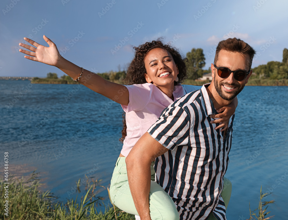 Poster Couple having fun near river at summer party